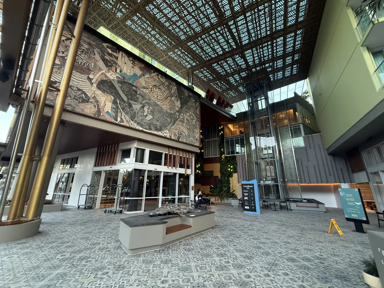 Bailey atrium with mural, patterned ceiling and gold-toned columns