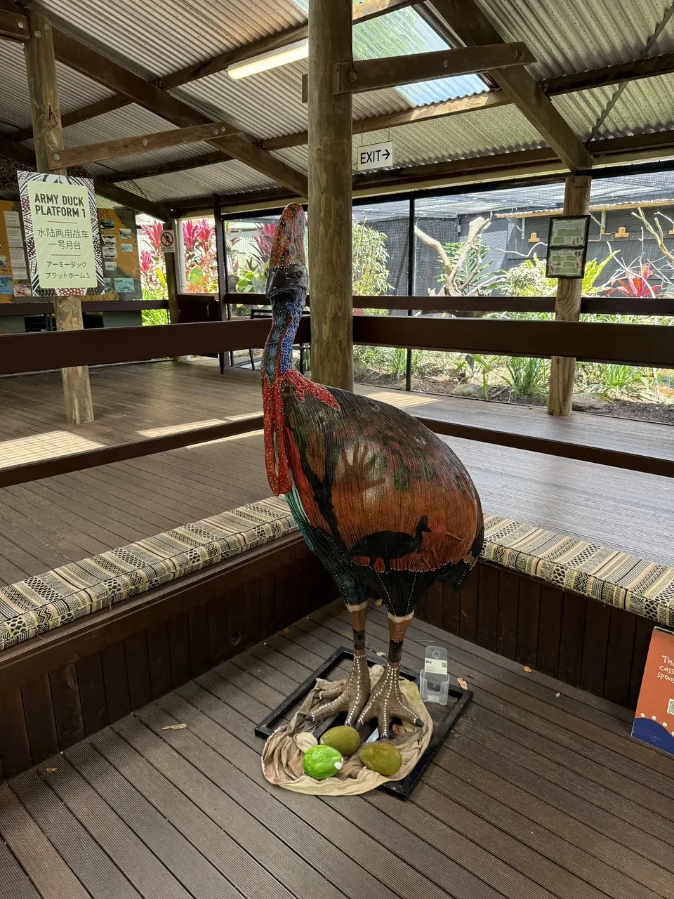 A painted cassowary statue beside the Army Duck platform sign