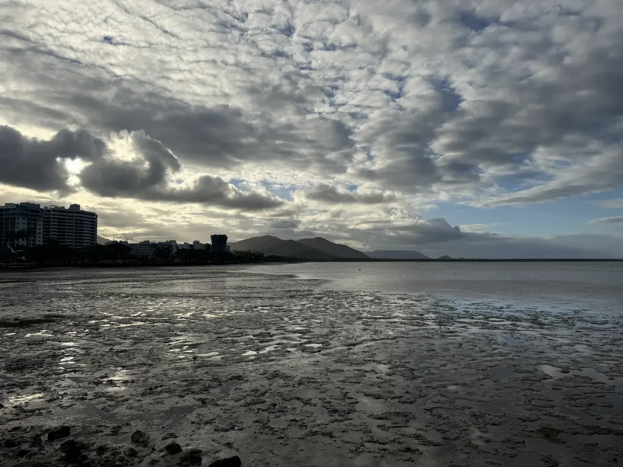 Cairns bay and city beneath dramatic clouds