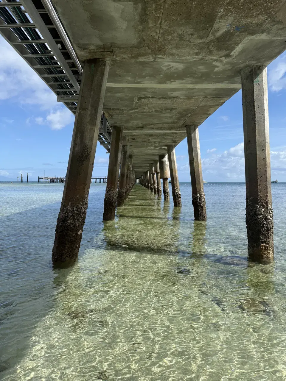Clear sea beneath the Green Island pier