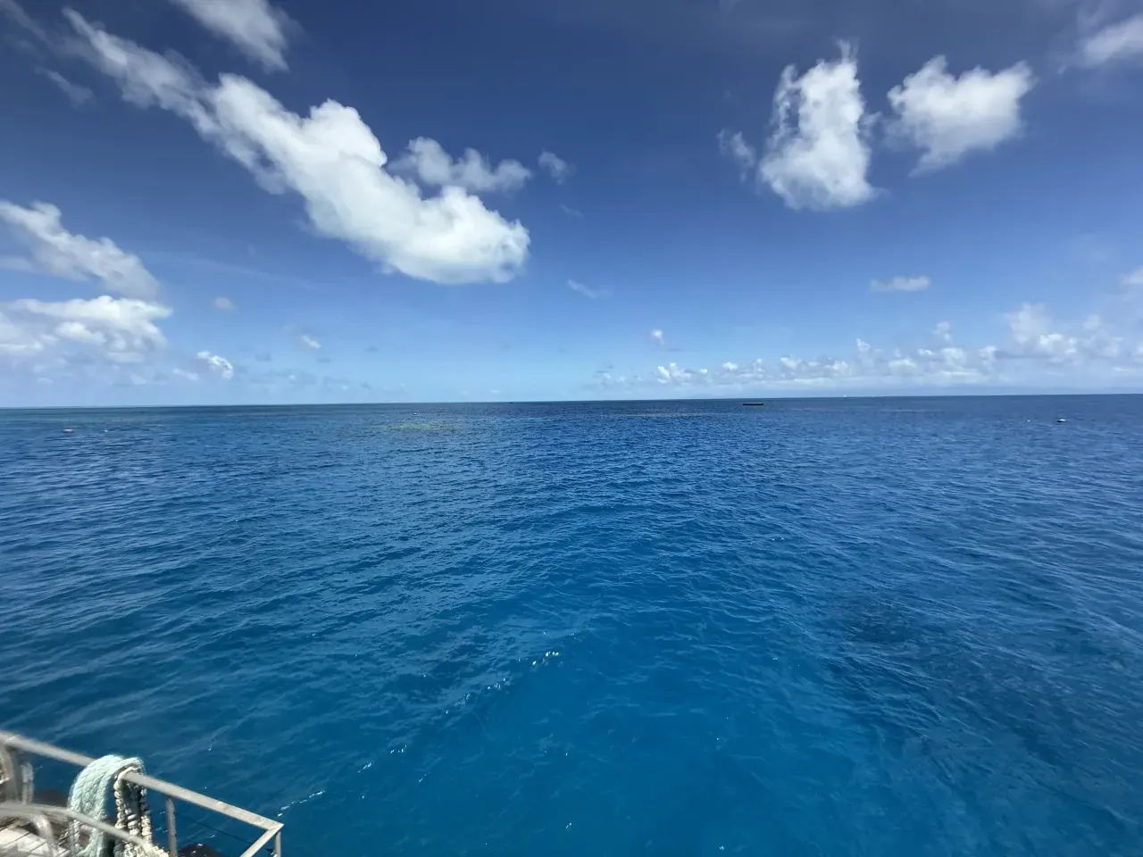 Open blue ocean beneath clouds at the Outer Reef
