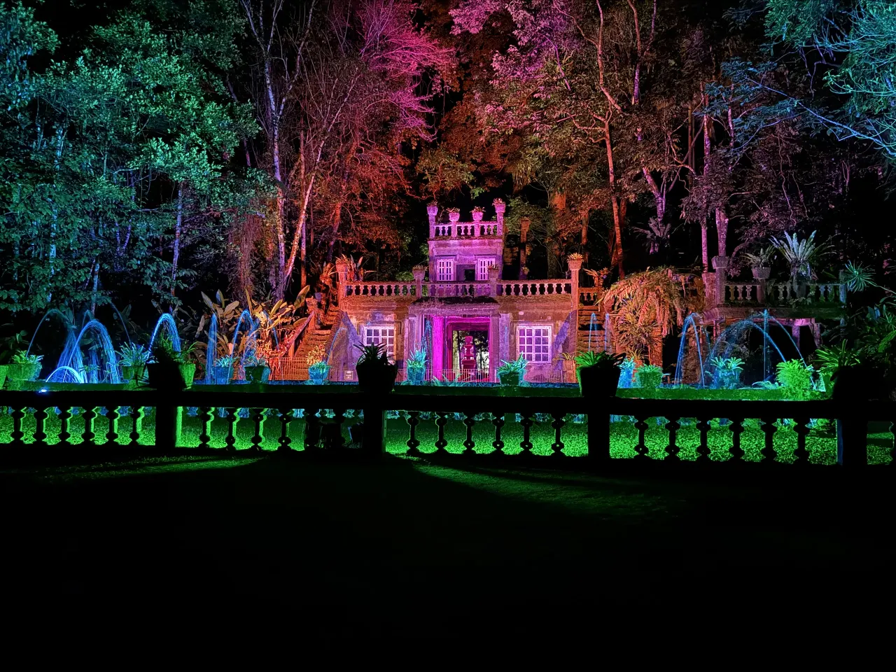 The castle lit in colour with fountains during the night show