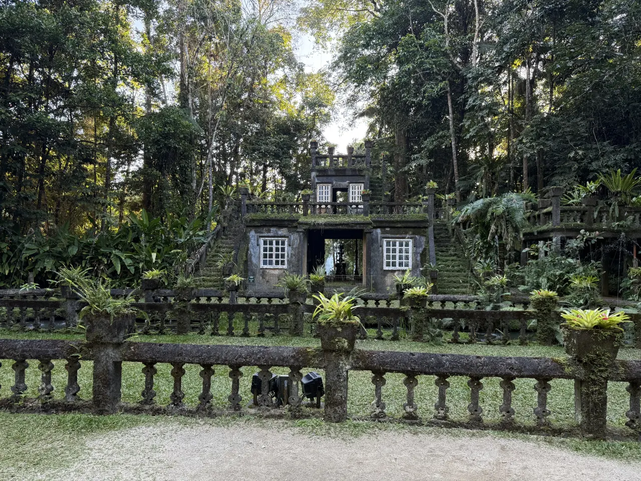 Moss-covered stone terraces surrounded by greenery
